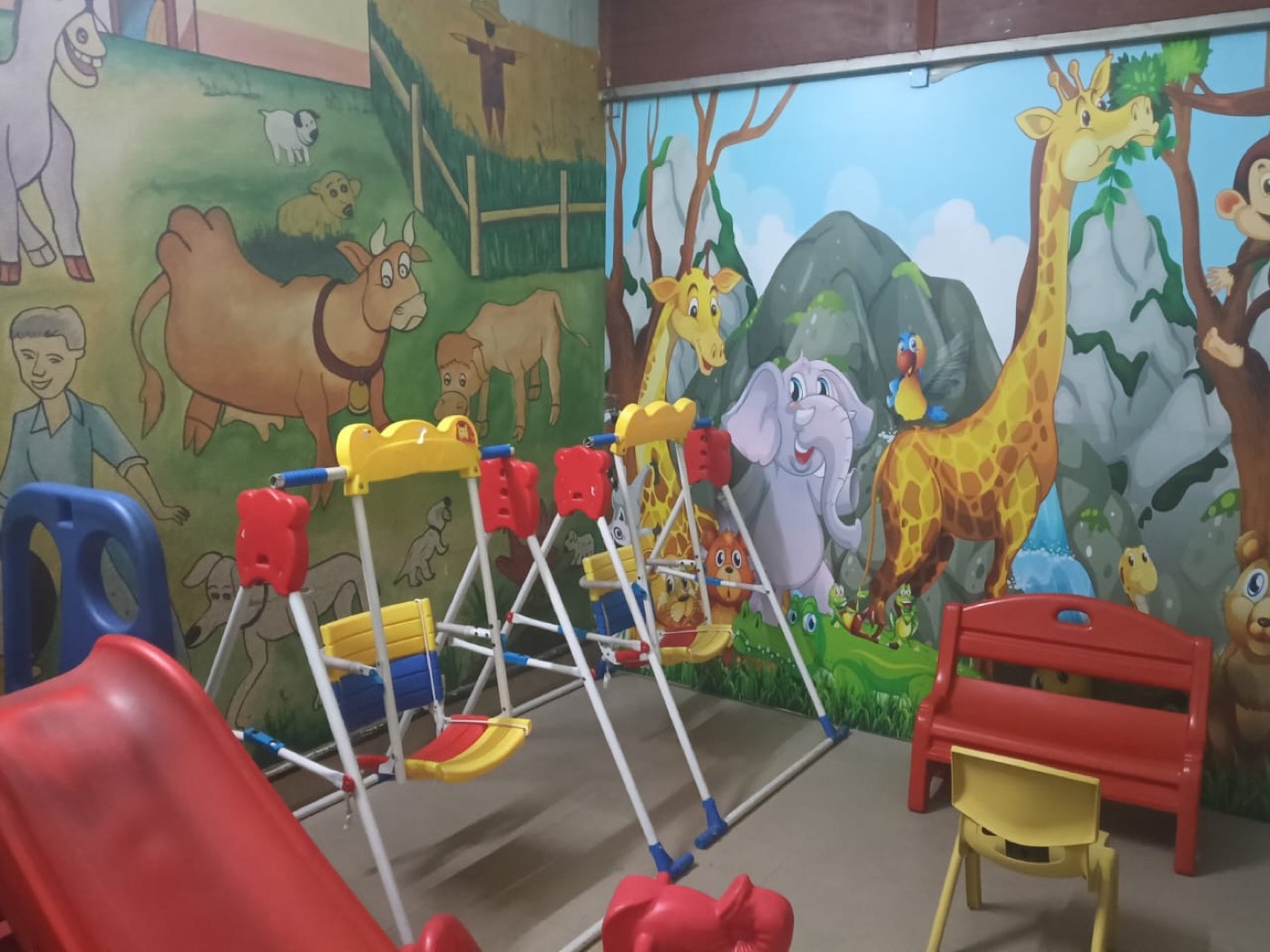 A colourful play room with animal murals at Skonis Wonders School