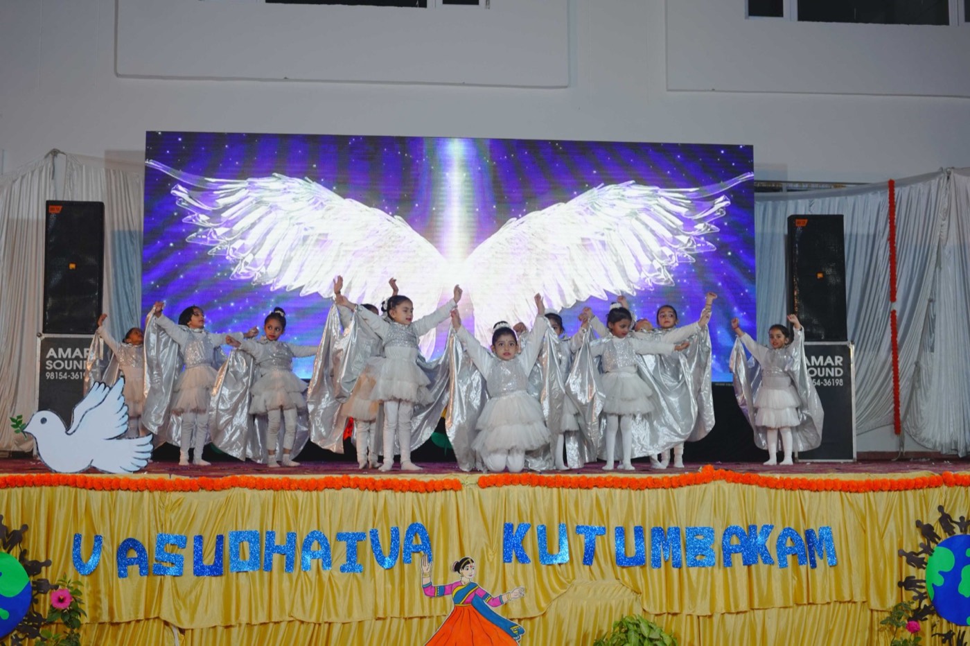 Children in white costumes performing