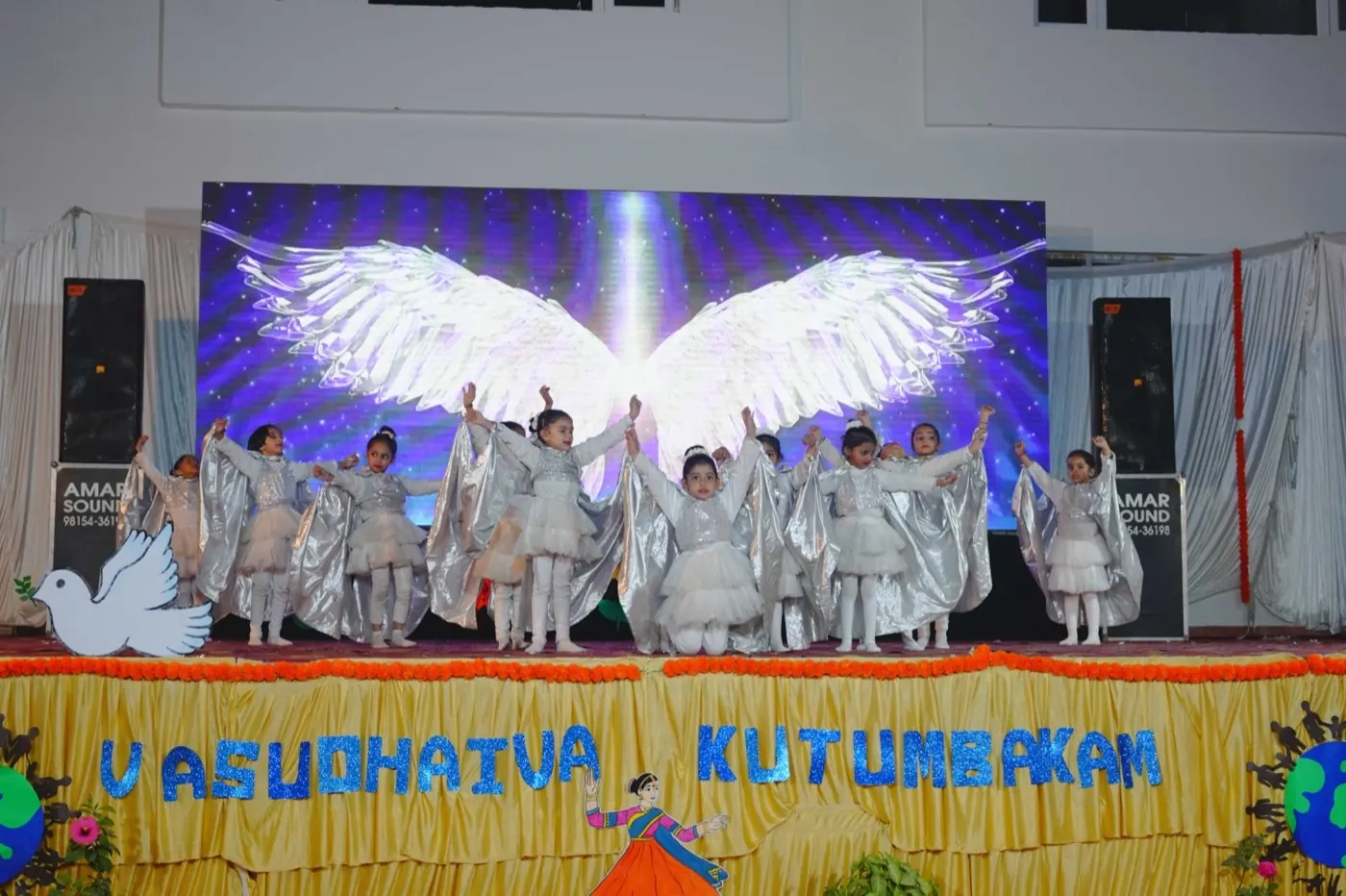 Children in white costumes performing